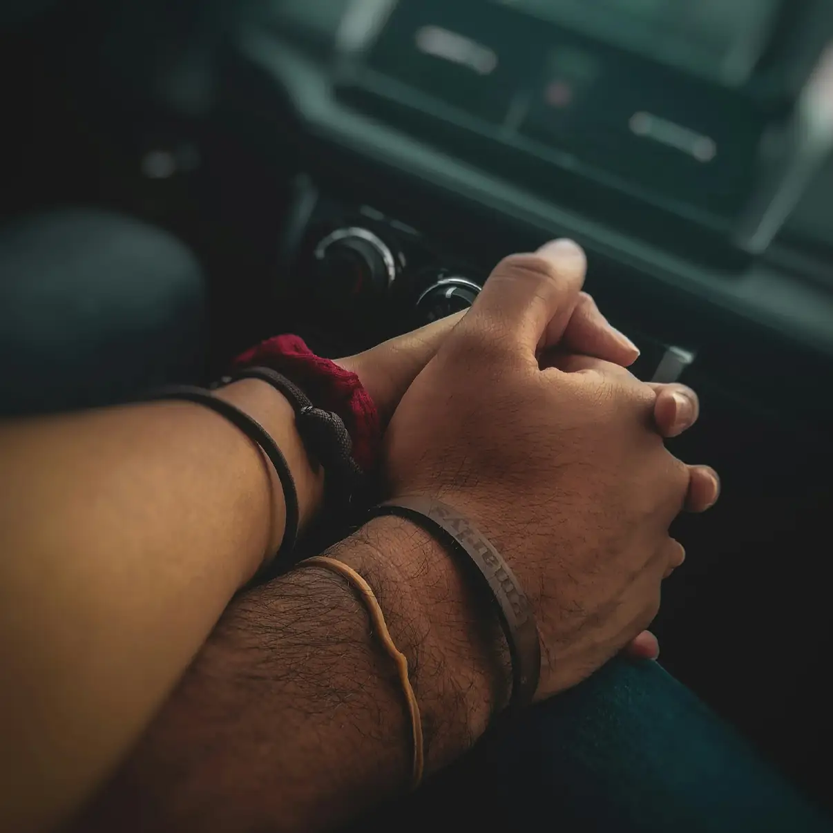 dp couple shaking hands in car